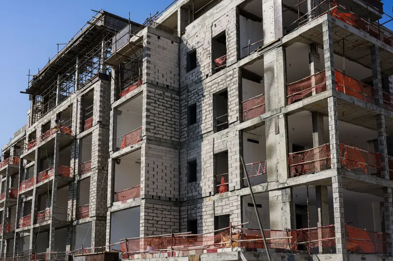 Mid-rise apartment building under construction with scaffolding